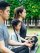 Happy Asian family is spending their holidays enjoying yoga in park together happily.